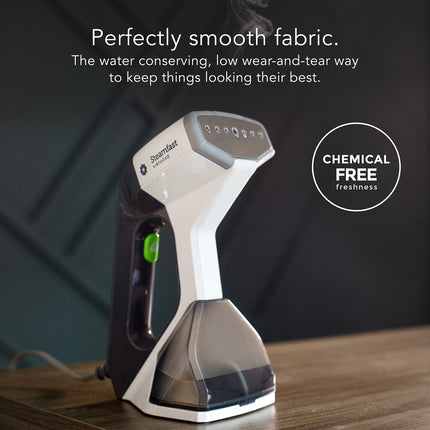 Steam cleaner on a wooden surface with text about fabric smoothing and chemical-free freshness.