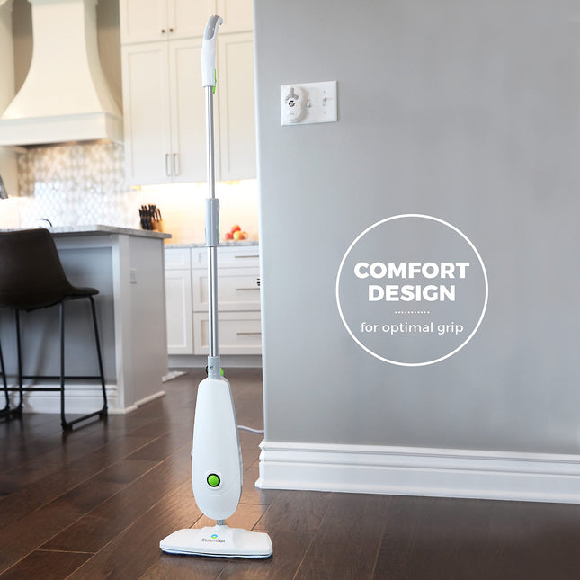 White steam cleaner on a wooden floor with a kitchen in the background, featuring 'Comfort Design' text.