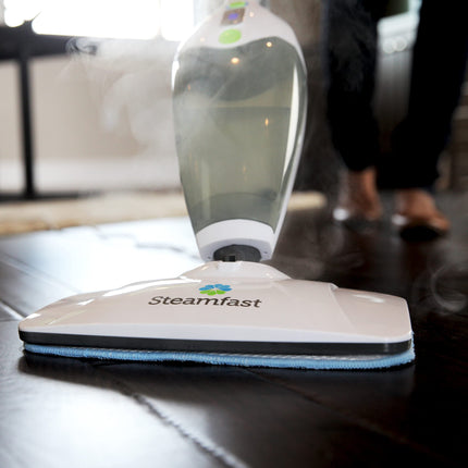 Steamfast steam cleaner on a wooden surface with a blurred background
