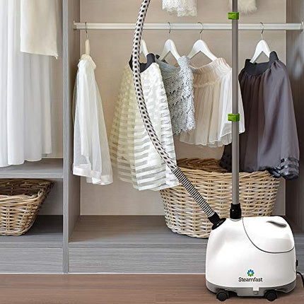 Steam cleaner in a room with clothes on hangers and baskets.