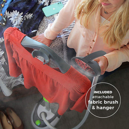 Person using a fabric brush and hanger attachment on a garment with text indicating included features.