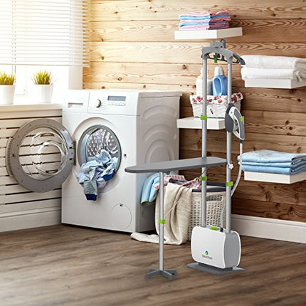 Laundry room with washing machine, dryer, and a standing steam rack with folded clothes.
