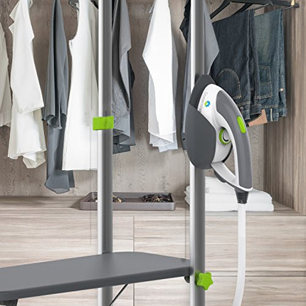 Clothing steamer on a stand with clothes hanging in the background