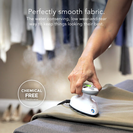 Hand using a steam iron on fabric with text about water conservation and low wear-and-tear.
