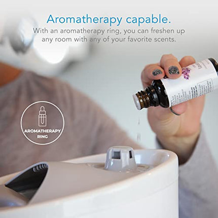 Person adding essential oils to a diffuser with aromatherapy ring branding.