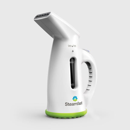 White handheld steamer with green base on a light gray background, featuring the Steamfast brand.