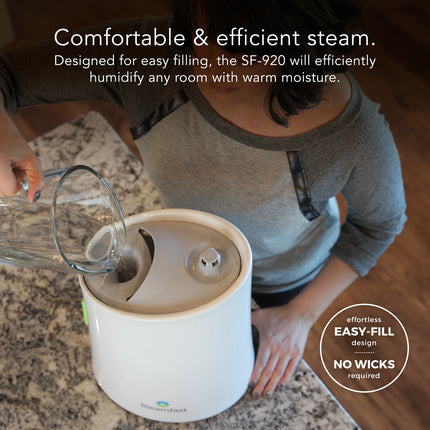 Person filling a humidifier with water on a countertop, with text highlighting features.
