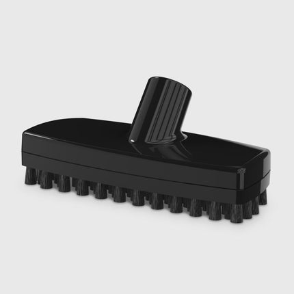 Black scrubber brush on a light gray background