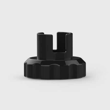 Black cylindrical object with a textured surface on a light gray background