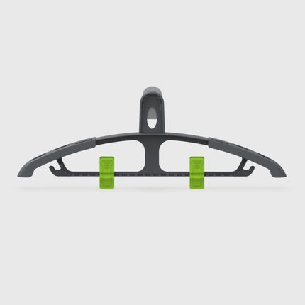 Black hanger with green clips on a light gray background