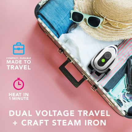 Compact travel iron with accessories on a pink background