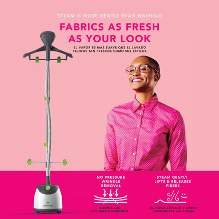 Person wearing a pink shirt with a steam cleaner on a pink background