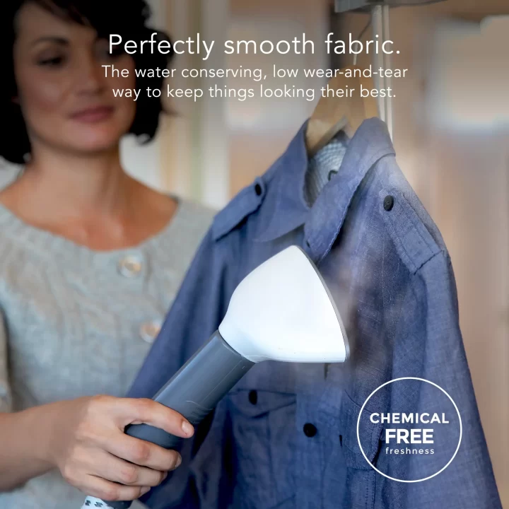 woman using a SF 407 fabric steamer to clean shirt with supporting text: Perfectly smooth fabric. The water conserving, low wear-and-tear way to keep things looking their best. Chemical free freshness.