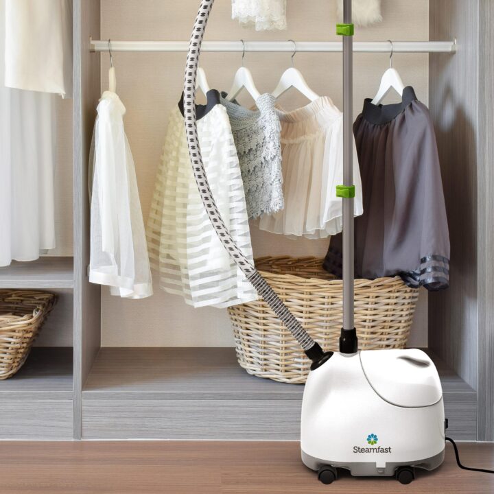 Lifestyle of a SF-407 Canister Steam Cleaner In Closet by clothes hung up.