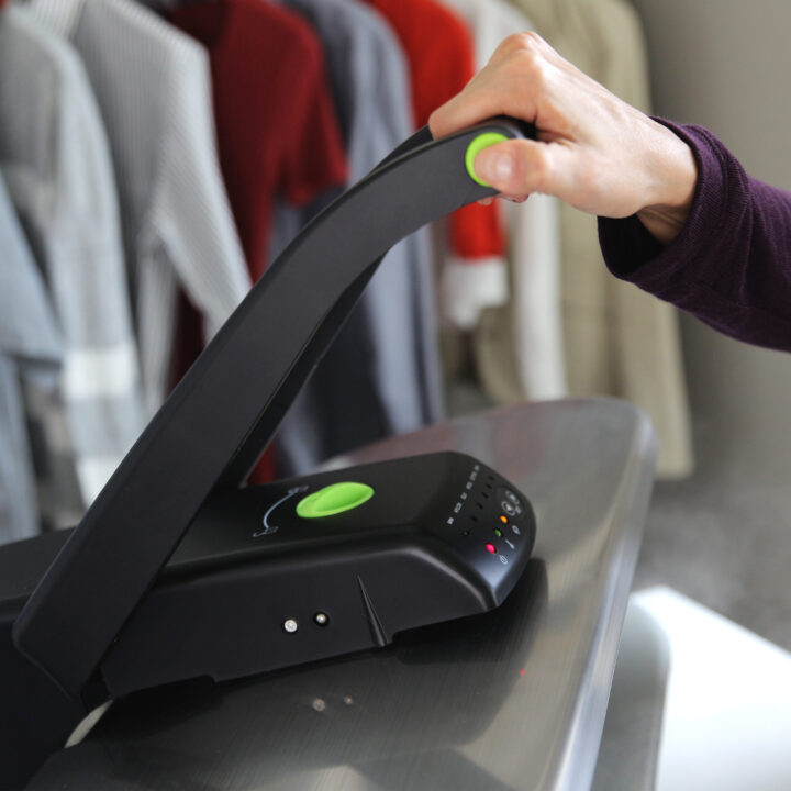 Woman holding the handle of a SF-680 Deluxe Digital Steam Press